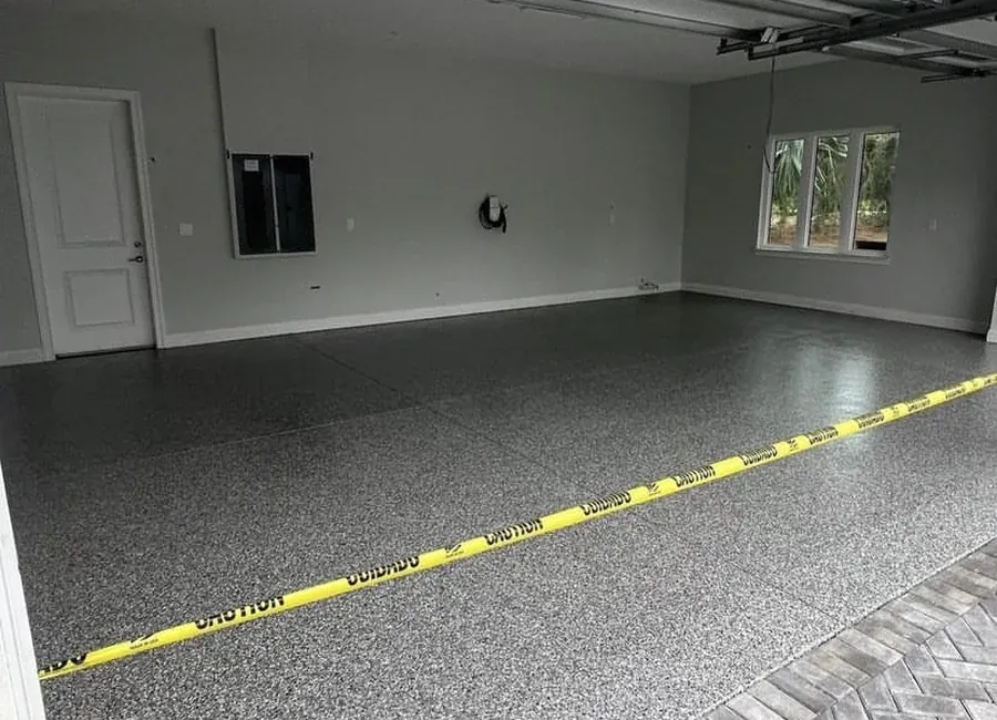 Garage interior with freshly painted walls and a coated floor