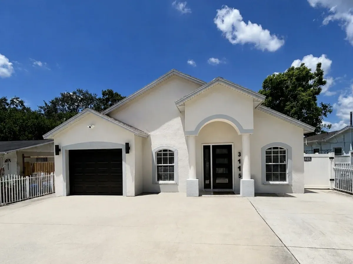 Freshly painted home exterior with clean trim and a bold front door