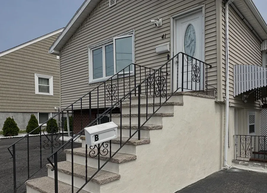 Building exterior repainted, with fresh stairs and railings
