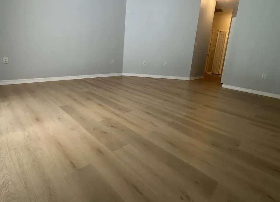 Bedroom with new warm-toned laminate flooring